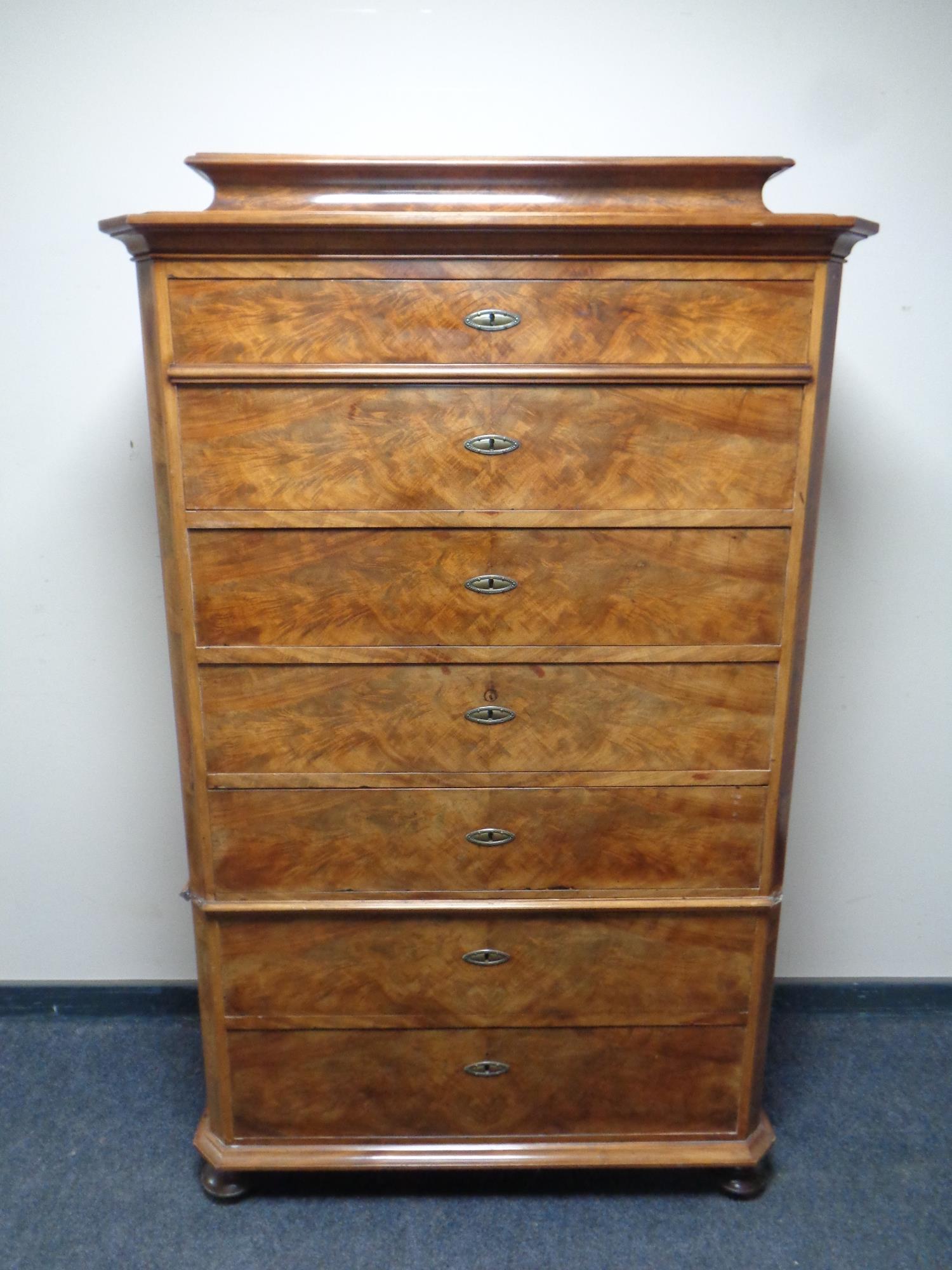 A 19th century mahogany seven drawer chest on bun feet