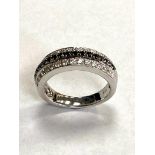 An 18ct white gold black and white diamond ring