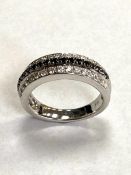 An 18ct white gold black and white diamond ring