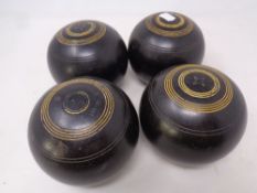 A set of four wooden lawn bowls