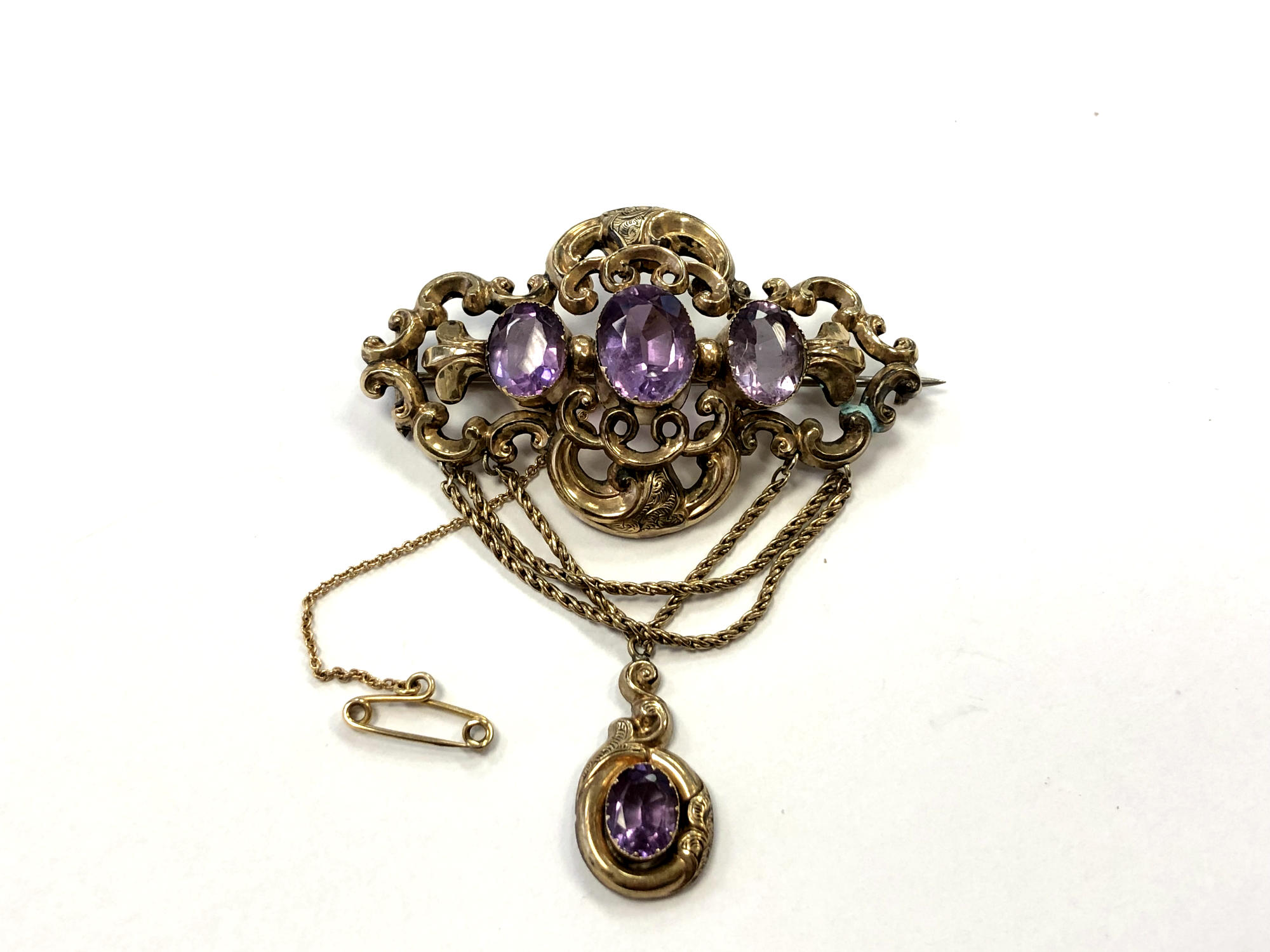 An ornate Victorian pinchbeck brooch