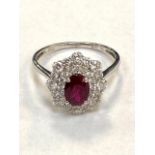 A ruby and diamond fancy cluster ring, approximately 0.81ct, ruby 1.03ct, size N/O.