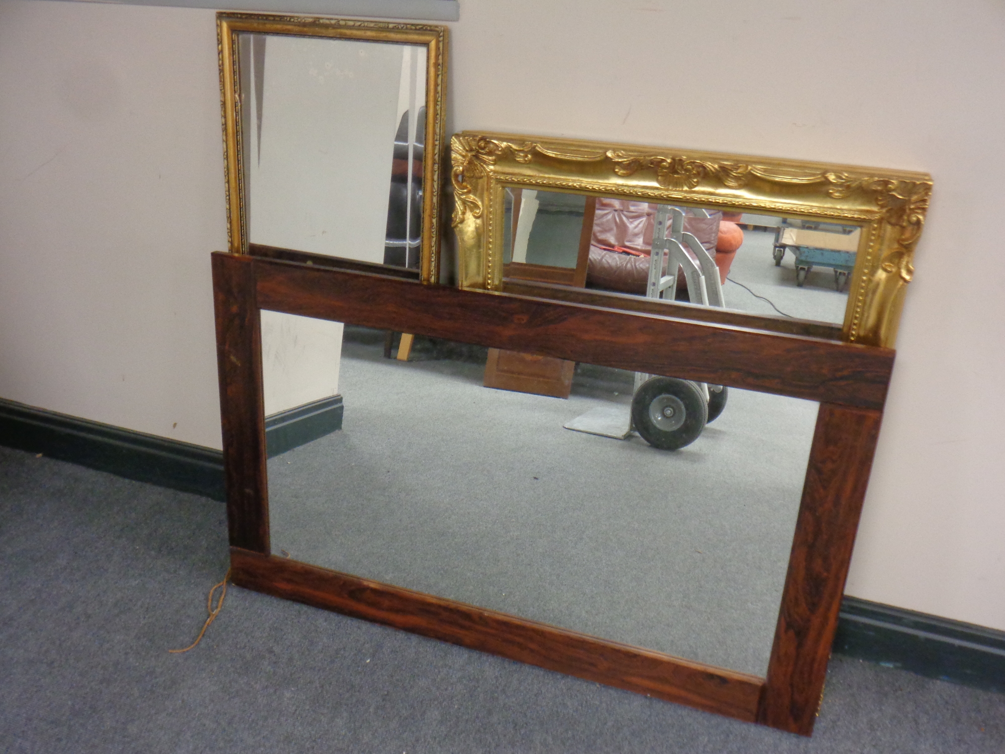 A mid century Danish rosewood framed mirror together with two further mirrors