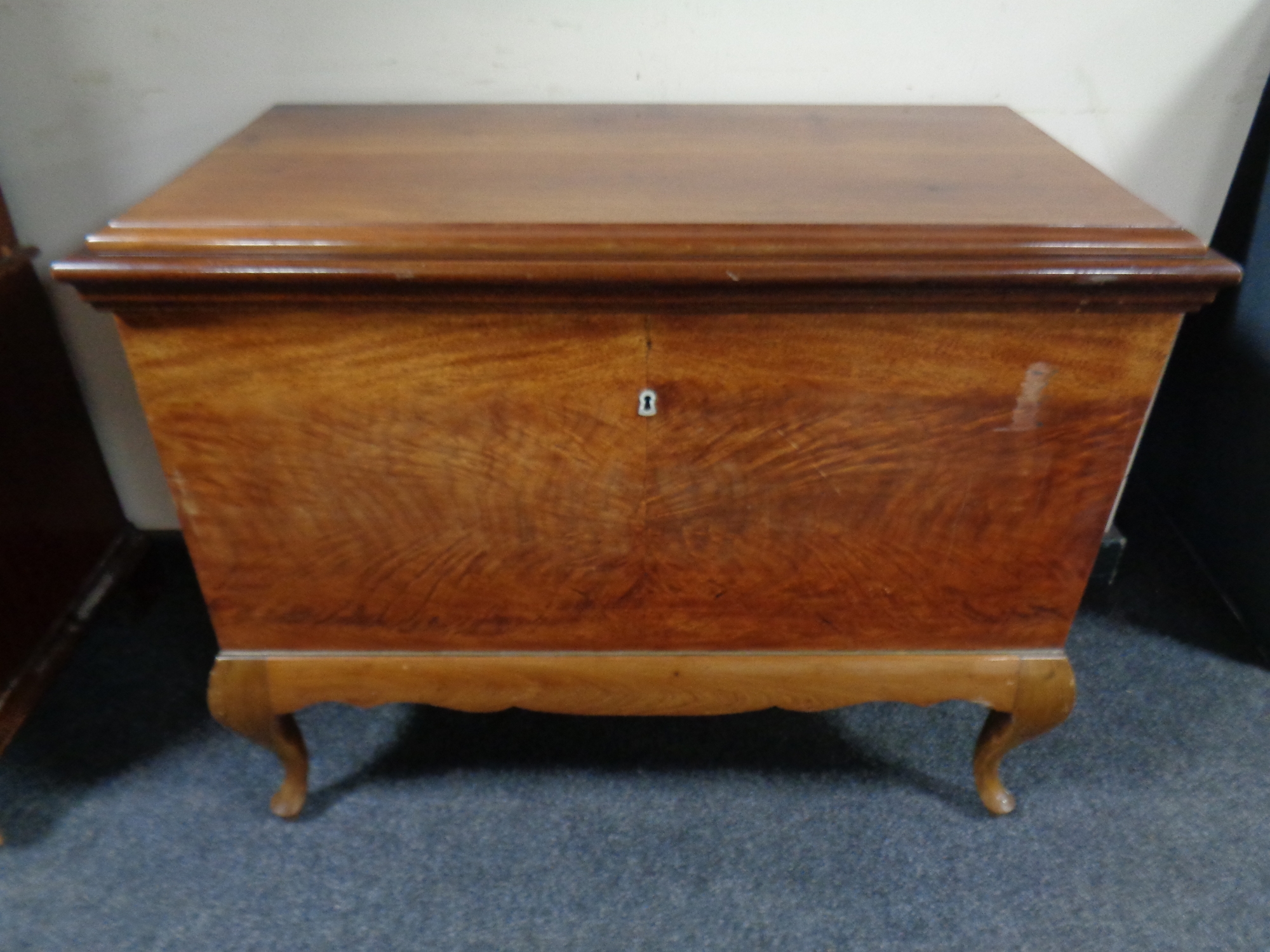 An antique mahogany fall fronted cabinet on cabriole legs