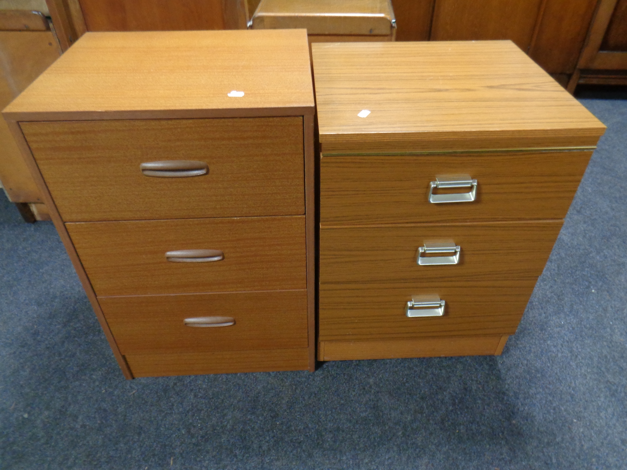 Two teak effect three drawer bedside chests