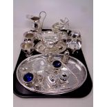 A tray of silver plated items including cream jug and sugar helmet on stand, pair of sauce boats,