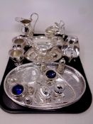 A tray of silver plated items including cream jug and sugar helmet on stand, pair of sauce boats,