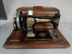 A vintage Jones Family C.S. hand sewing machine in case.
