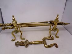 A heavy quality brass three piece fire companion set, with pair of stands and fire dog front.