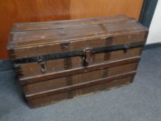 An antique oak bound domed shipping trunk