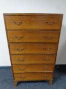 A mid 20th century walnut six drawer chest