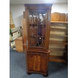 A mahogany Regency style concave corner display cabinet