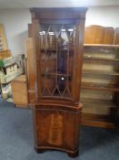 A mahogany Regency style concave corner display cabinet