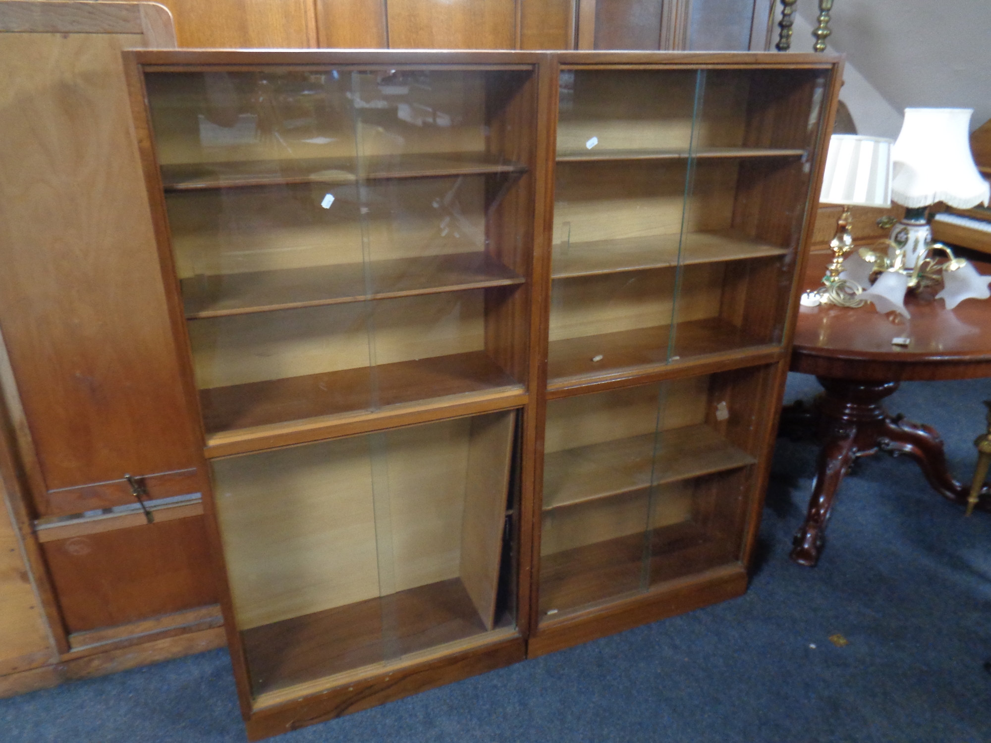 A pair of mid century sliding glass door bookcases