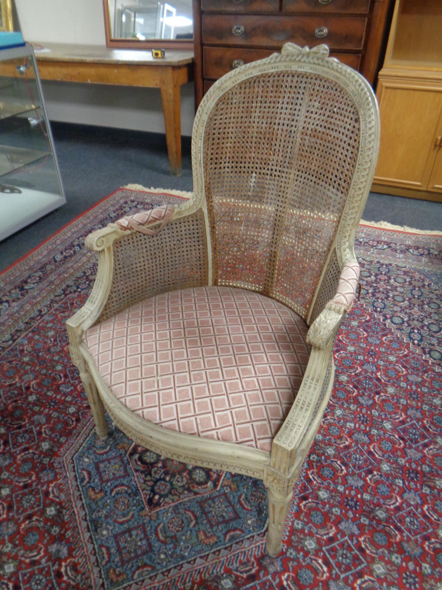 An antique French begerre backed armchair