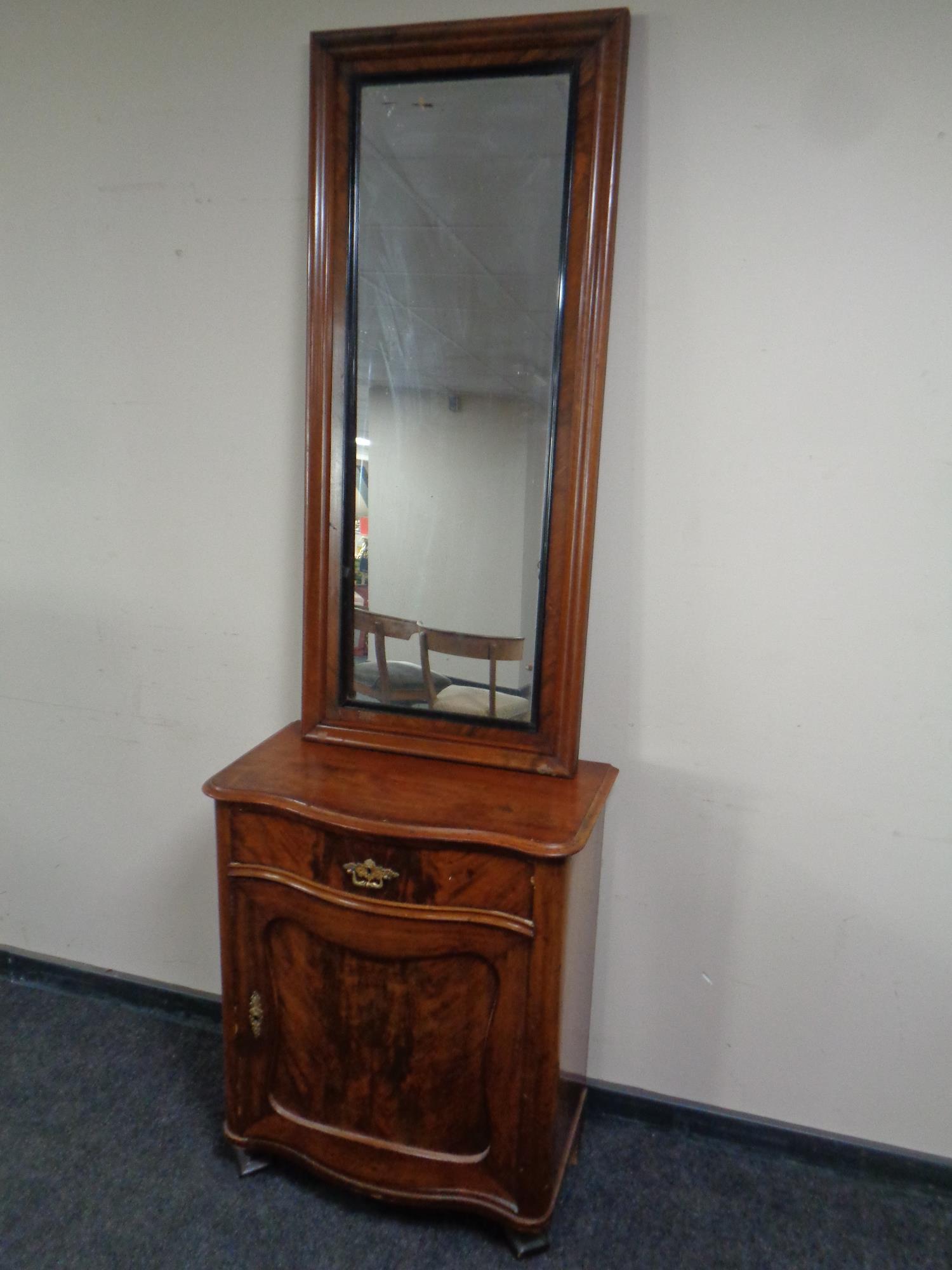 A late 19th century mahogany serpentine fronted hall cabinet fitted a drawer with hall mirror