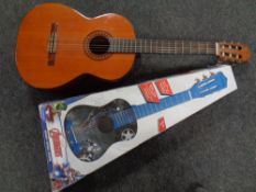 A Kasruga model G-312 acoustic guitar together with a further child's Marvels guitar in box.