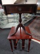 A nest of three tables in a mahogany finish together with a pedestal sofa table with inset leather
