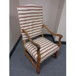 A 20th century beech framed high backed armchair in striped fabric