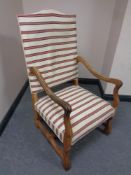 A 20th century beech framed high backed armchair in striped fabric