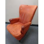 A twentieth century armchair in red leather (a/f)