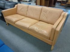 A Danish Stouby three seater settee in tan leather