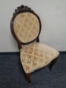 A carved beech framed occasional chair in classical fabric