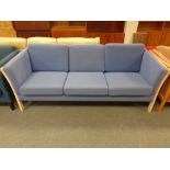 A Danish wooden framed three seater settee in blue fabric