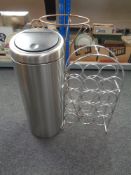 A wine rack together with a stainless steel bin and metal jardiniere stand