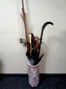 A ceramic stick pot containing selection of walking sticks, crooks, 19th century curtain rail,