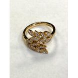 An 18ct gold diamond leaf design ring, size L/M.