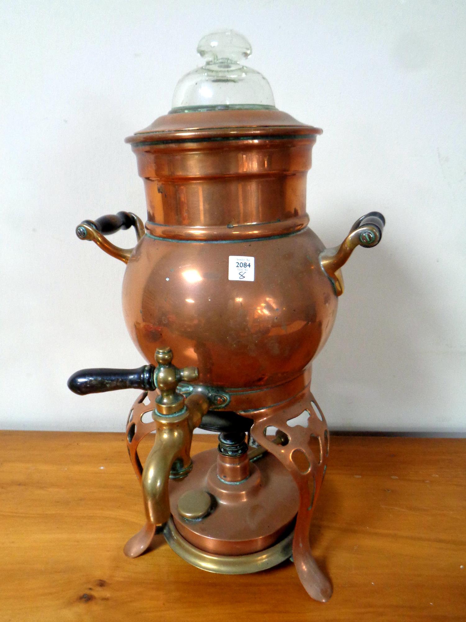 A Victorian copper coffee pot on stand with burner