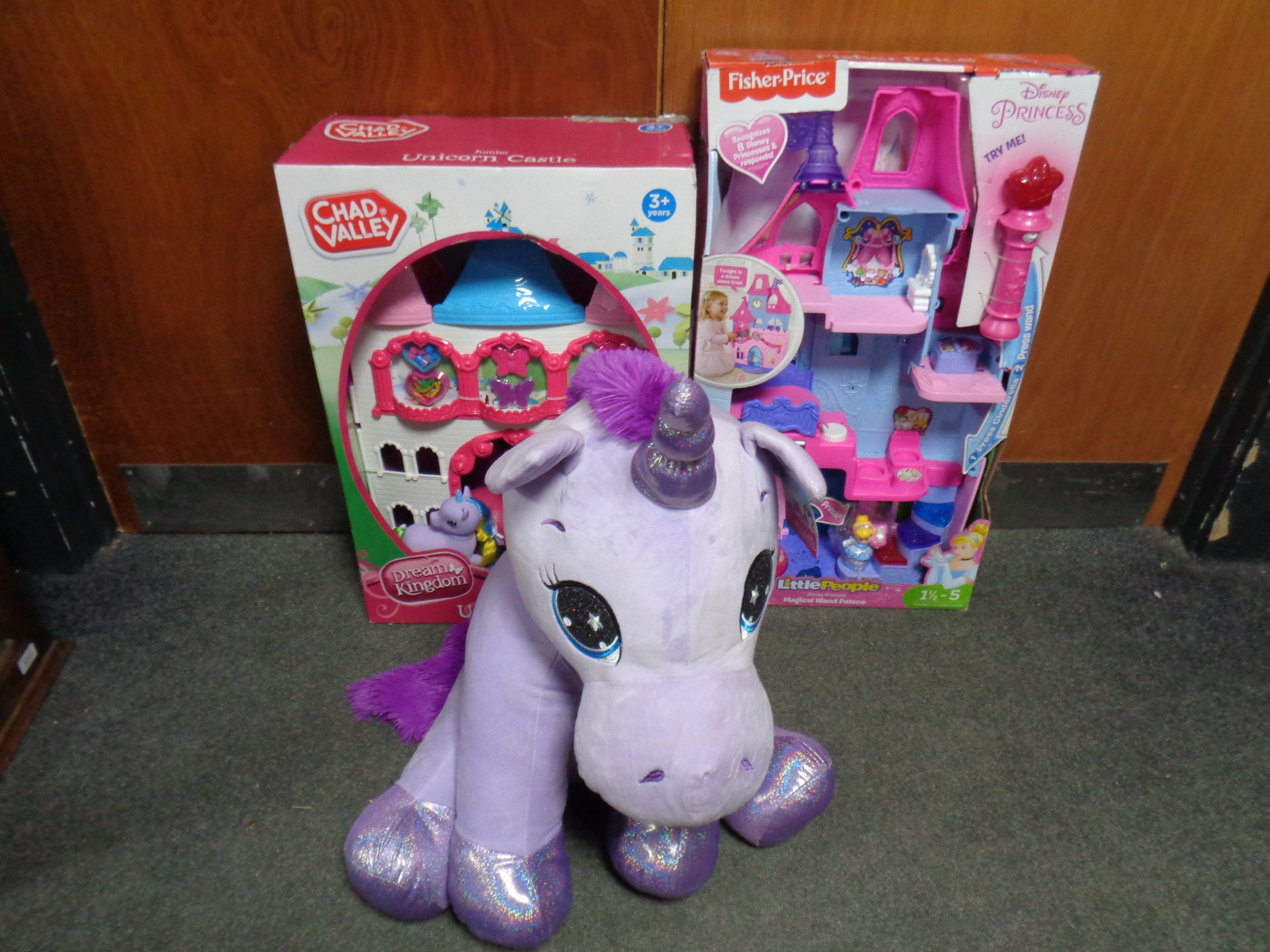 A Chad Valley Unicorn castle together with a Fisher Price little people Wand palace, both boxed,