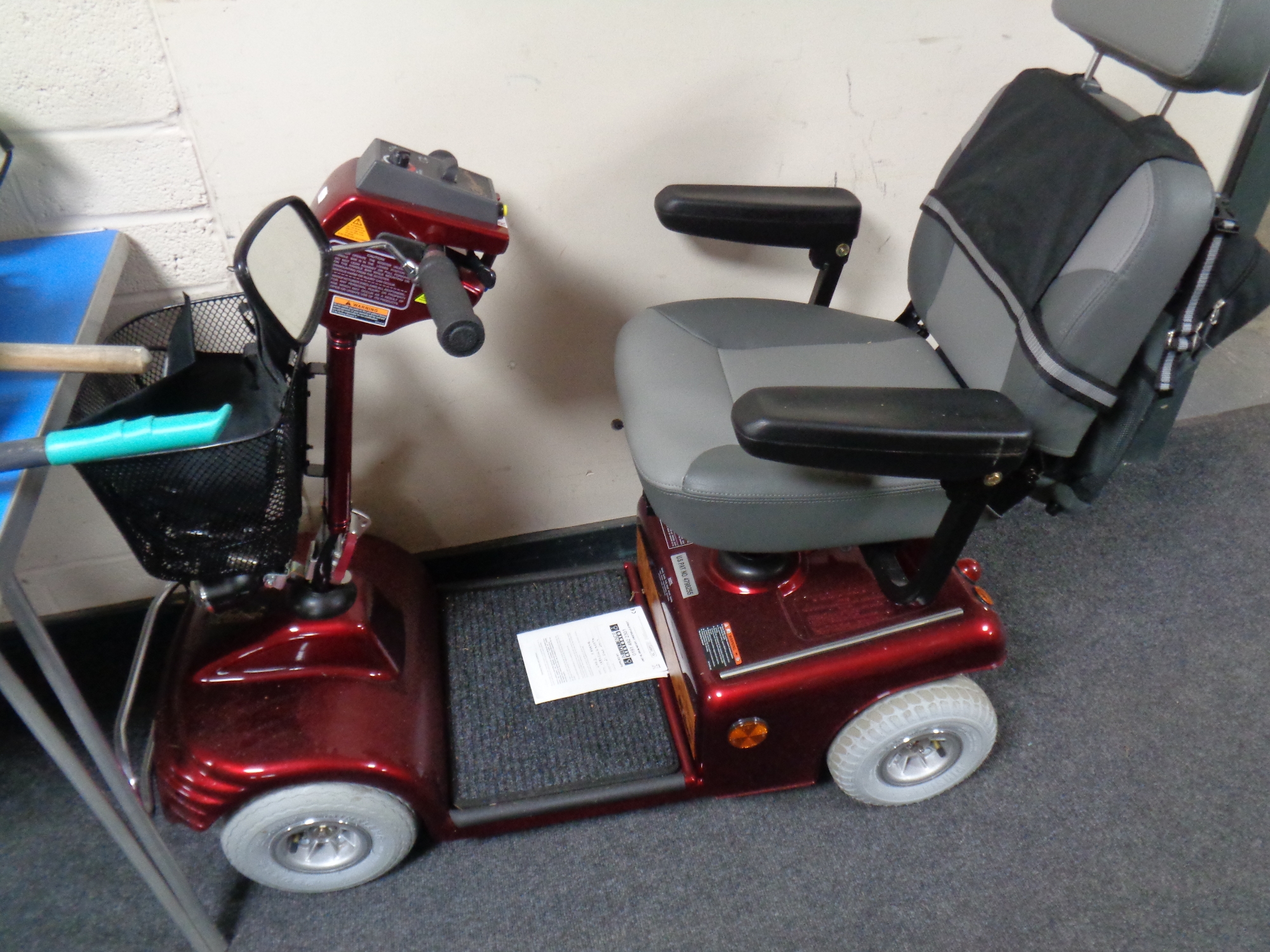 A Shop Rider Sovereign mobility scooter with keys and charger