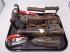 A tray of antique and later irons