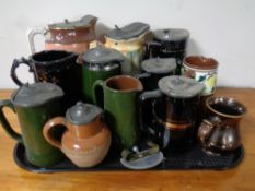 A tray of lidded steins and jugs