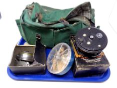 A canvas fishing bag containing a Beaudex reel, boxed, fishing hooks,