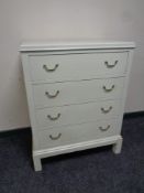 A 20th century painted pine four drawer chest on raised legs