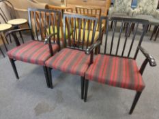 A pair of painted rail backed armchairs together with matching dining chair in striped fabric