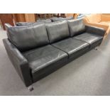 A Danish three seater in black leather on chrome legs