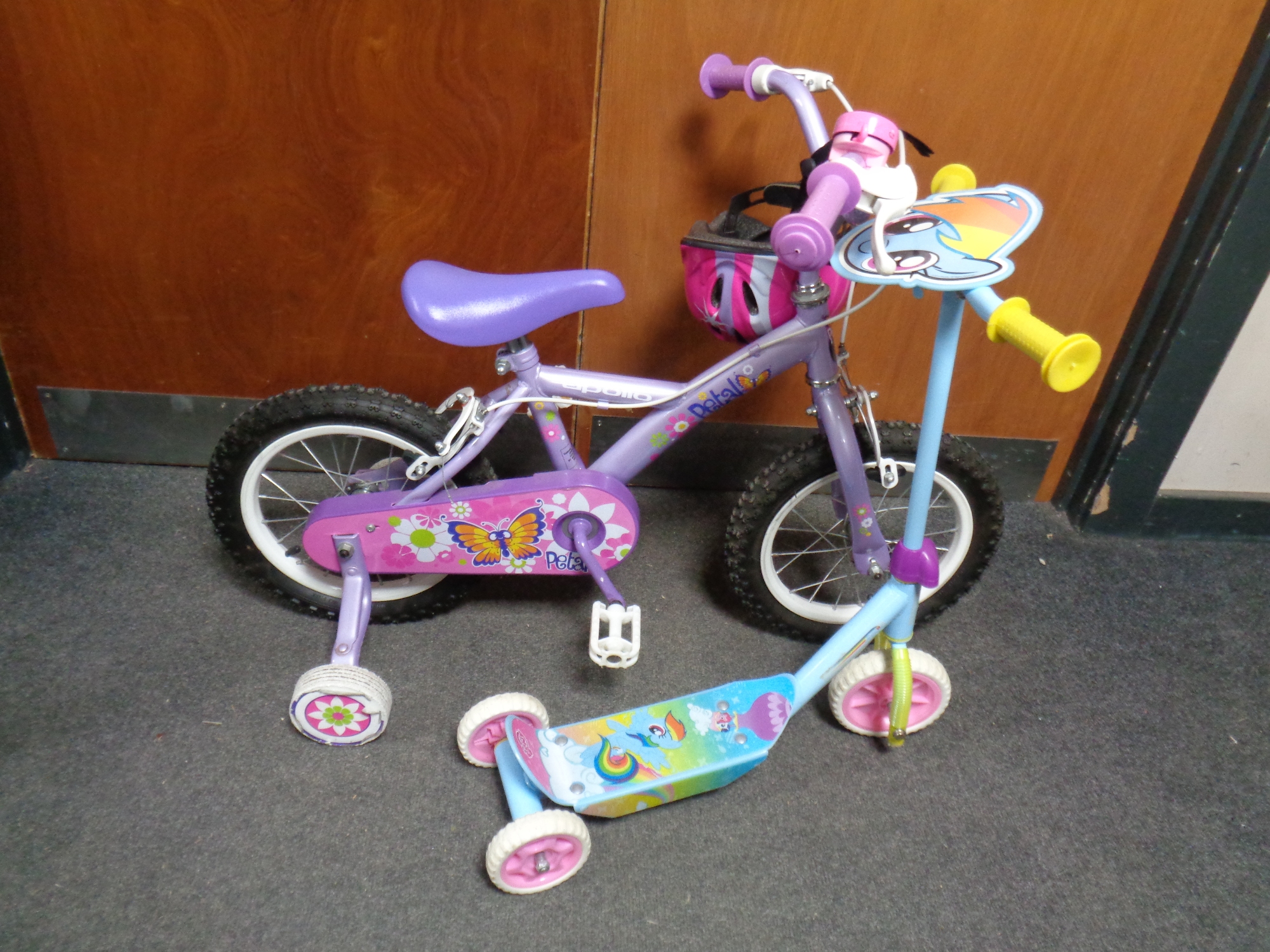 An Apollo petal girls bike with stabilisers and helmet together with a scooter