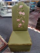 A 20th century high backed bedroom chair upholstered in green fabric