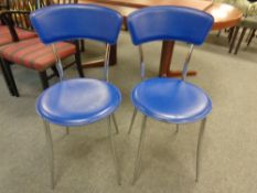 A pair of blue vinyl and tubular metal dining chairs