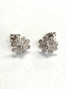 A 9ct white gold diamond set flower stud earrings