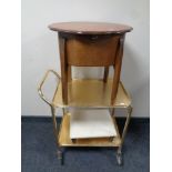 A 20th century shaped sewing box on raised legs together with a gilt metal two tier tea trolley and