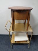 A 20th century shaped sewing box on raised legs together with a gilt metal two tier tea trolley and