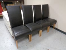 A set of 4 Brown leather upholstered high back dining chairs