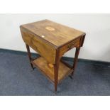 A Victorian inlaid rosewood two tier flap sided serving trolley fitted a drawer