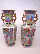 A pair of Canton porcelain hexagonal baluster twin handle vases,