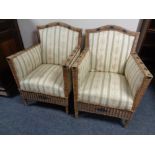 A pair of wicker armchairs upholstered in a striped fabric